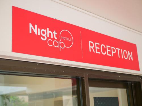 a red sign on the side of a building at Nightcap at Hinterland Hotel Nerang in Gold Coast