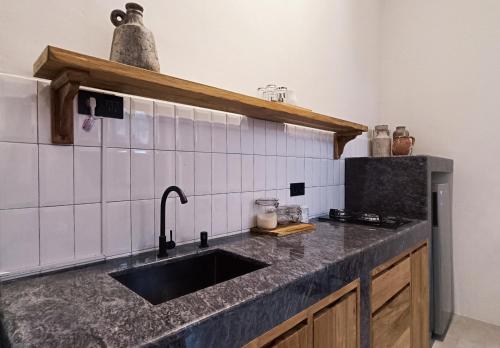 a kitchen with a sink and a counter top at Casa Benna - Salatiga in Salatiga