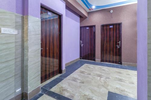 a hallway with three elevators in a building at OYO Mastic Marvell in Noida