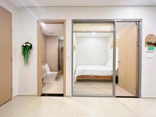 une chambre avec une porte en verre menant à une chambre dans l'établissement YK Home - The Song Apartment, à Vung Tau