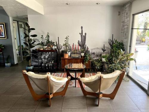 a room with two chairs and a table with plants at Desert Oasis- *Pool and Hot Tub* in Phoenix