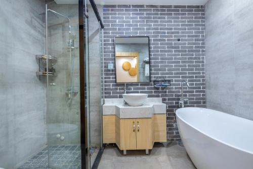 a bathroom with a sink and a shower and a tub at Qingshan Yuandai Boutique Homestay Yangshuo in Yangshuo