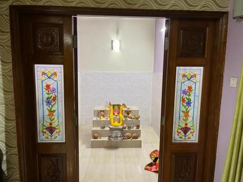 a room with two doors with stained glass at SAHAY VILLA RESORT in Durbate