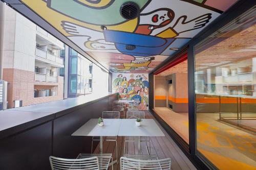 a restaurant with a mural on the ceiling at lyf Ginza Tokyo in Tokyo