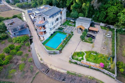 an aerial view of a house with a swimming pool at Qingshan Yuandai Boutique Homestay Yangshuo in Yangshuo