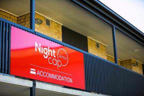 a sign on the side of a building at Nightcap at Kawana Waters Hotel in Kawana Waters