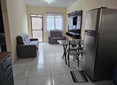 a kitchen and living room with a stainless steel refrigerator at Apartamento boa vista rr in Boa Vista