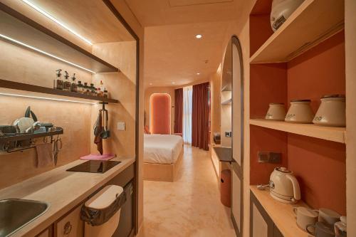 a bathroom with a sink and a room with a bed at Bstudio in APEC Mandala Mũi Né in Phan Thiet