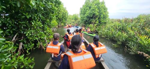 a group of people on a boat in the water at Bell Farms and Resorts in Munroe Island