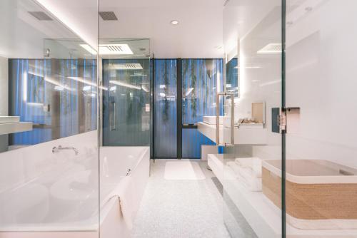 a bathroom with a tub and a sink at Y11 azabu hotel by Mrt in Tokyo