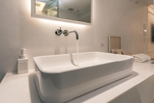 a white bathroom with a sink and a mirror at Y11 azabu hotel by Mrt in Tokyo