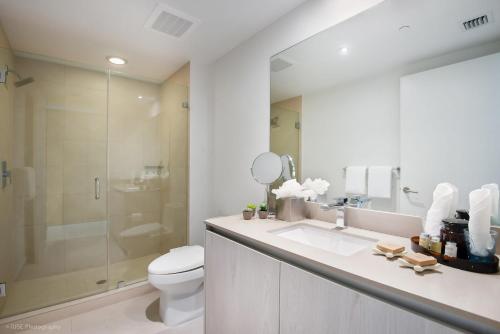 a bathroom with a toilet and a sink and a shower at Zen Vacation Rentals Ocean Front at Lyfe Resort in Hollywood