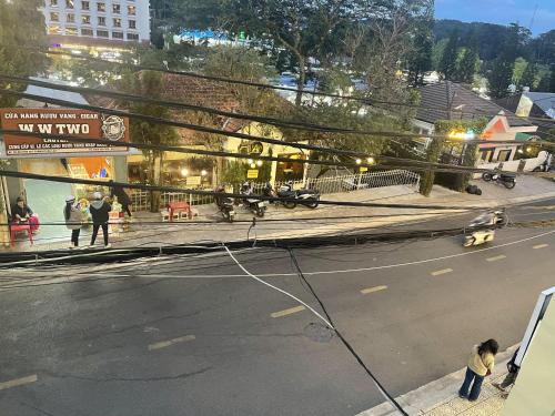a view of a street with people walking on the sidewalk at NA NI in Da Lat