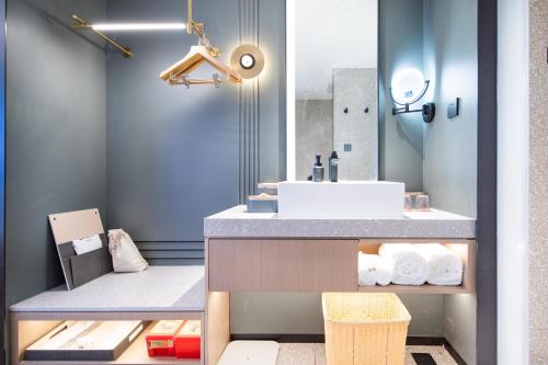 a bathroom with a sink and a mirror at Atour S Hotel Jinan Shunhe in Jinan