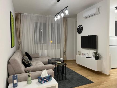 a living room with a couch and a tv at Apartman EMA in Banja Luka