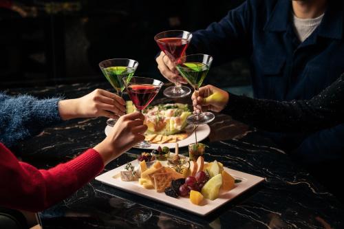 a group of people drinking wine at a table with food at Four Points by Sheraton Seoul, Guro in Seoul