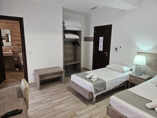 Habitación de hotel con 2 camas y espejo en Napoli Suites, en San Julián