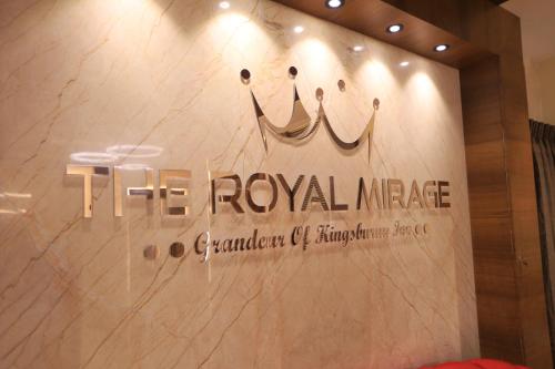 a wall with a sign for a royal image at Kings Bury Inn in Kumbakonam