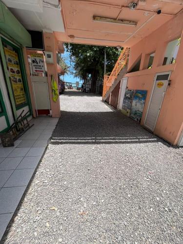 an empty hallway of a building with a walkway at Ebrahim Flats - Grand Baie Beach in Grand Baie