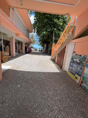 an empty walkway between two buildings at Ebrahim Flats - Grand Baie Beach in Grand Baie