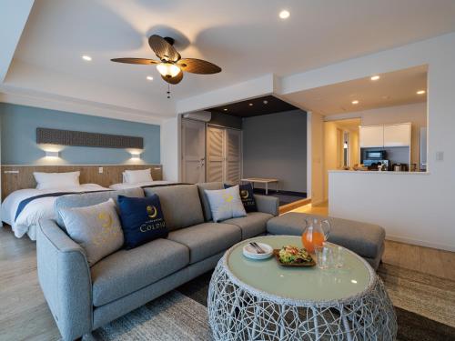 a living room with a couch and a bed at Aqua Palace Chatan by Coldio Premium in Chatan