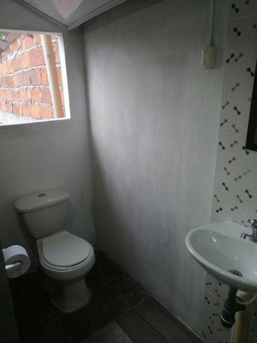 a bathroom with a toilet and a sink at Casa lowcost relajación in La Dorada