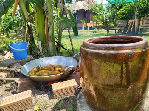 a bowl of food sitting next to a bowl of fruit at MEKONG DANIEL HOMESTAY CAN THO in Can Tho
