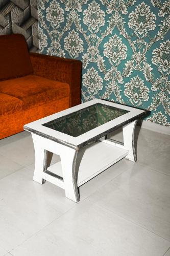 a white coffee table in a living room with a couch at HOTEL AL ZAM ZAM in Nagpur