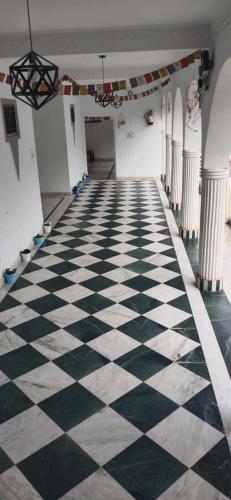 an empty hallway with a black and white checkered floor at Govind Home Stay in Rishīkesh