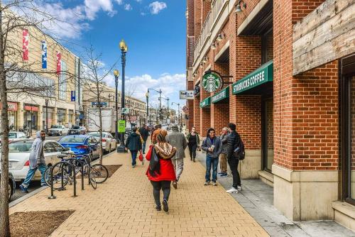 a group of people walking down a city street at Charming 2BD1BA in Hip Area - Near Metro in Washington