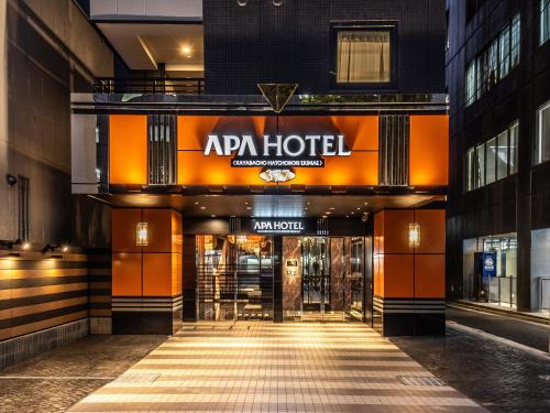 APA Hotel Kayabacho Hachobori Ekimae في طوكيو: مدخل الفندق مع وجود علامة الفندق على المبنى