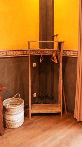 a wooden table with a mirror and a basket at Rumah Dharma Boutique Villa in Magelang