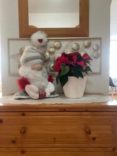 a stuffed animal sitting on top of a dresser at Apartmán Karin in Huty