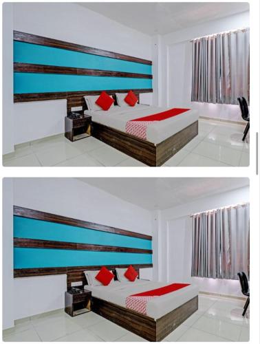 Camera bianca con 2 letti e cuscini rossi di HOTEL MAHIMA a Gandhinagar