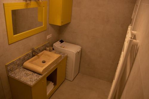 a small bathroom with a sink and a toilet at Blue Joy Bukovina Aparthotel in Suceava