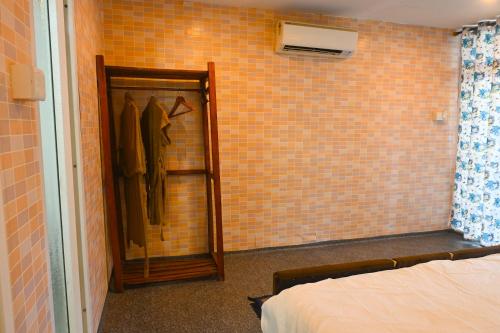 a bedroom with a mirror and a tiled wall at SUNBATH beach EXOTICA in Canacona
