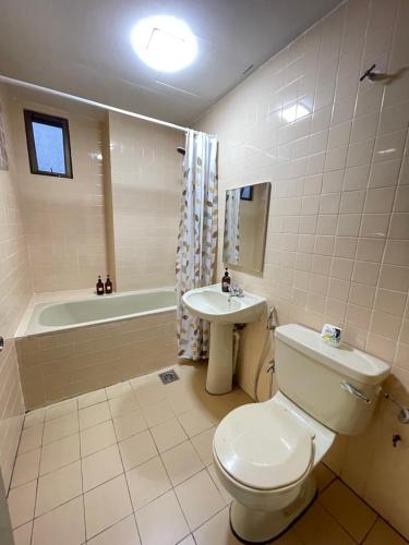 a bathroom with a toilet and a sink and a tub at Cosy Music Home at Genting View Resort 3R2B 9pax by Jen dehome in Genting Highlands