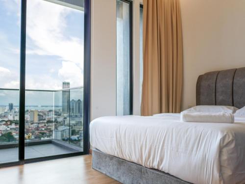 a bedroom with a bed and a large window at Beacon Executive Suite by Uptrend Home Management in George Town