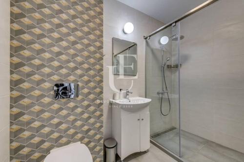 a bathroom with a toilet and a sink and a shower at Oslo: A modern furnished apartment with parking in Sofia
