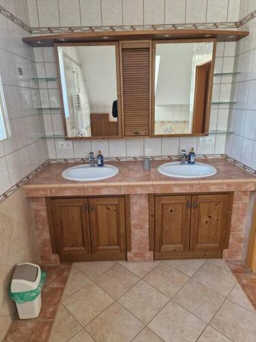 a bathroom with two sinks and two mirrors at Apartment am Stadtrand zu Graz 