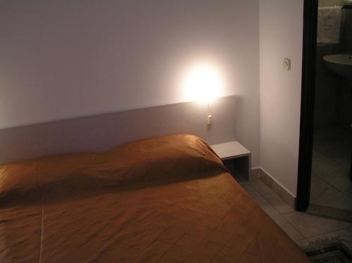 A bed or beds in a room at Apartments Villa Ypsilon