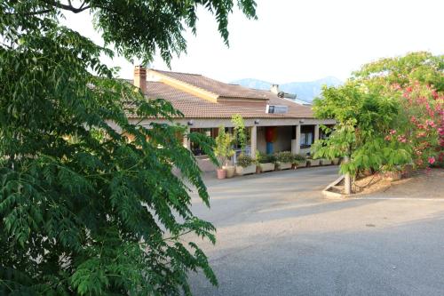 a building with a parking lot in front of it at Camping Les Couchants in Casaglione