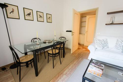 a living room with a dining room table and chairs at Italianflat - Palazzo Zeiner in Verona