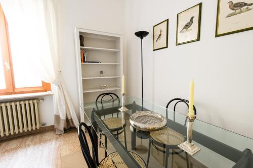 a dining room with a glass table and chairs at Italianflat - Palazzo Zeiner in Verona