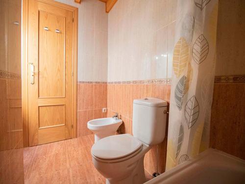 a bathroom with a toilet and a sink at Apartamentos Canfranc 3000 in Canfranc-Estación