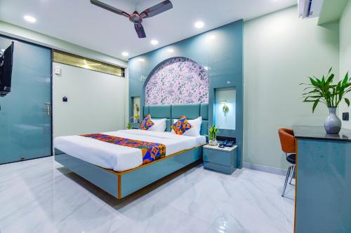 a bedroom with a king sized bed and a window at FabHotel Subh Hari in Jaipur