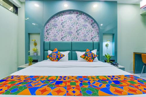 a bedroom with a large bed with a colorful bedspread at FabHotel Subh Hari in Jaipur