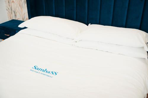 a white bed with white pillows on top of it at SambaSS Boutique Apartment in Capua