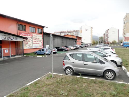 a row of parked cars in a parking lot at Apartments EMIZA in Samokov