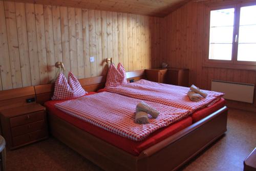 a bedroom with a bed with two shoes on it at Chalet Sepp in Belalp